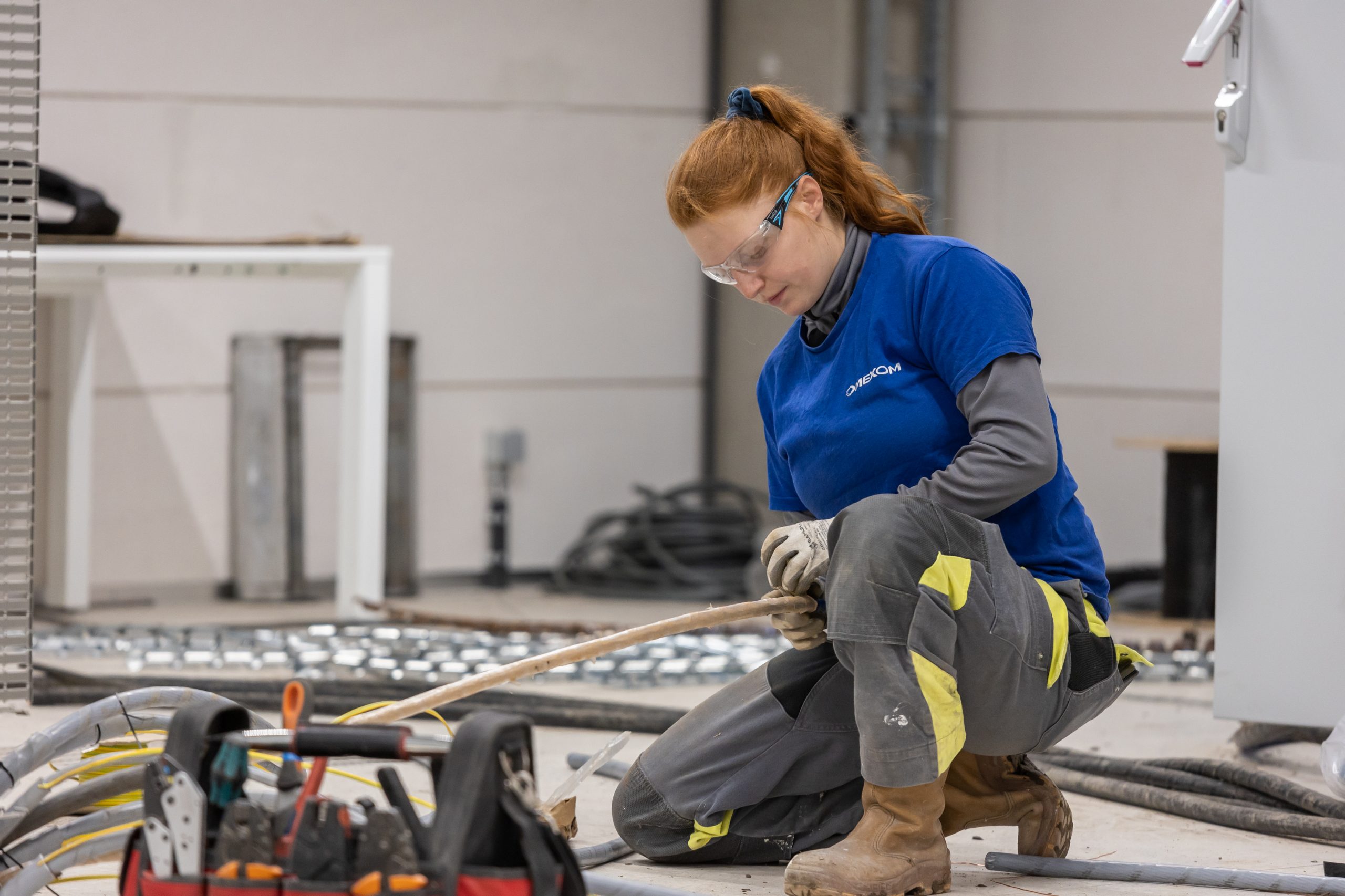 An Omexom employee working on cables at the substation