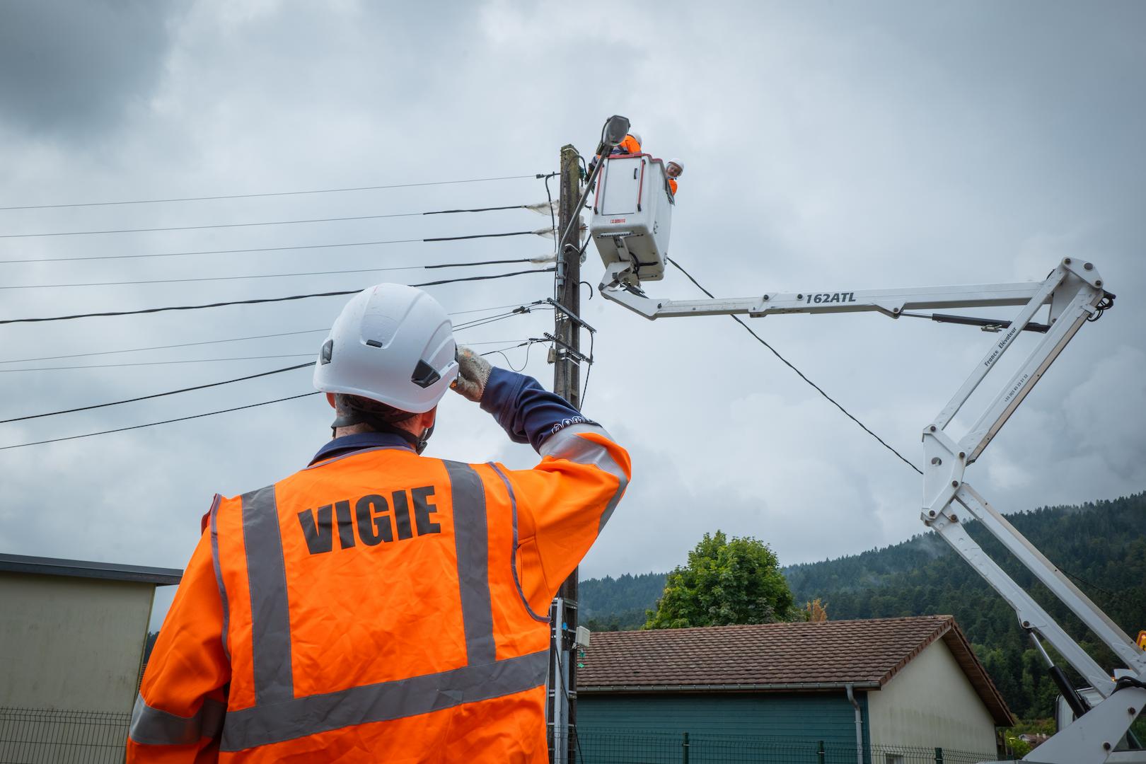Aerial basket lift operation on overhead power lines supporting a regional electricity distribution service in a residential area